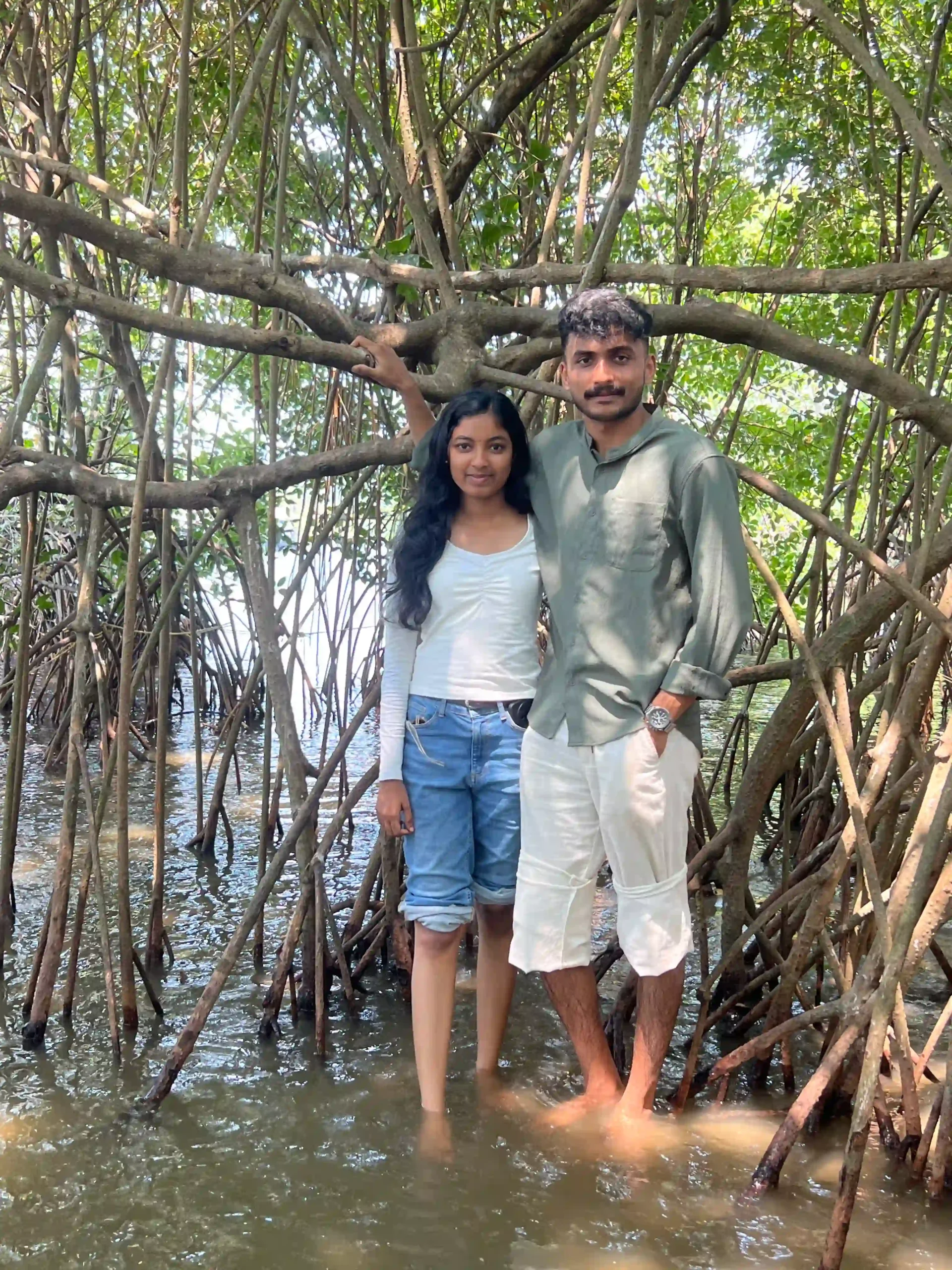 Couple standing inside the mangrove root cave