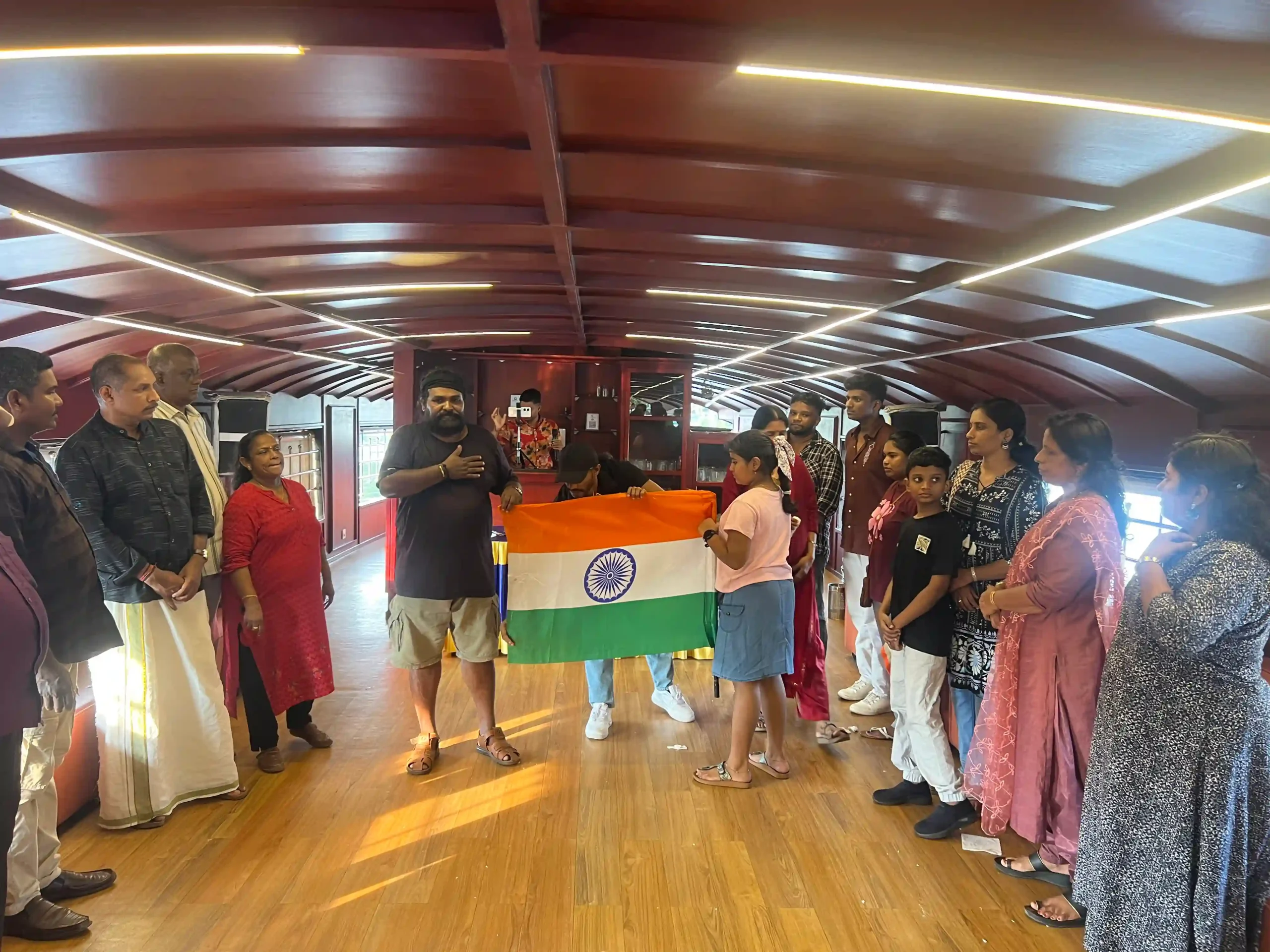 ANTS members holding Indian flag aboard the Ashtamudi houseboat